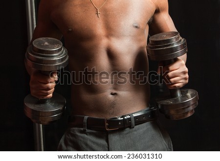 Black man with big weights.Physical education.