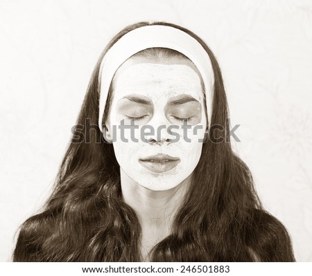 cleansing mask on her face girl long hair