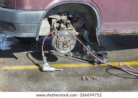 car tire on the service without wheels. professional tool. rusty brake disc. Details lever of the truck.