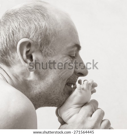 Dad kissing baby feet