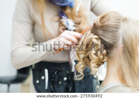 professional stylist performs wedding hairstyle female curly hair