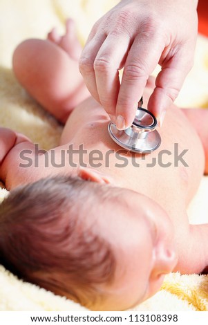 Stethoscope listening to a baby\'s heart beat