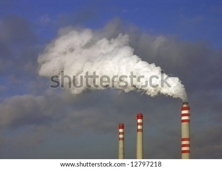 stock photo : factory fumes from chimney lighting sunlight