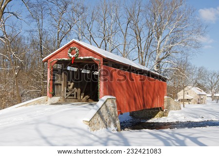 Pool Forge Covered Bridge with snow on a bright winter day in Lancaster County, Pennsylvania, USA.