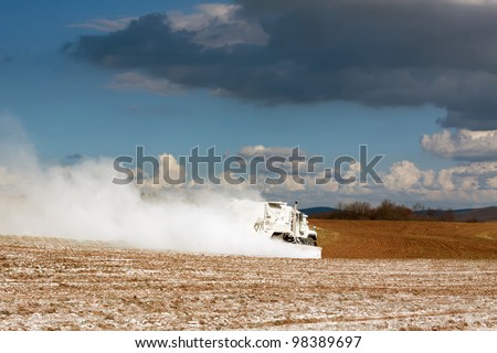 A truck spreading powdered limestone on farmland to improve soil properties. Lancaster County,Pennsylvania,USA.