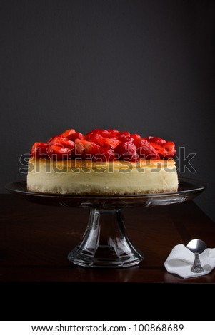 cheese cake /  cheese cake topped with glazed strawberries.