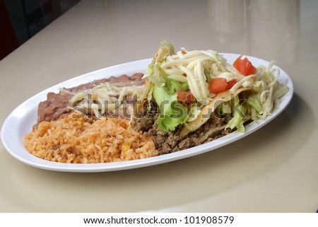 Tacos / A plate of Shredded meat tacos. served with rice and meat.