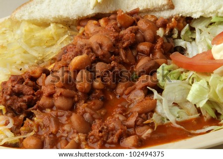 chili beans / Plate of chili beans. served as a meal with hash brown, salad, and bread.