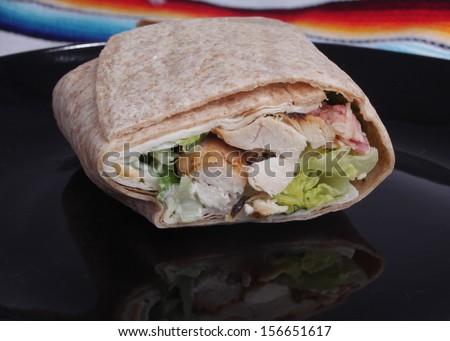 Chicken Wrap / Small Chicken wrap on a black plate. This shot was taken with a Canon Mark II.
