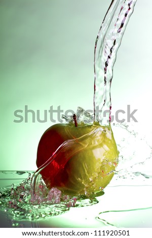 Green apple water splash with white background, high speed splash