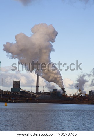 factory with steam and blue sky