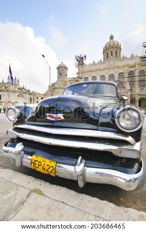 HAVANA, CUBA - JANUARY 28, 2012: Old classic car parked in front of the Revolution museum, formerly Presidential Palace until 1959.