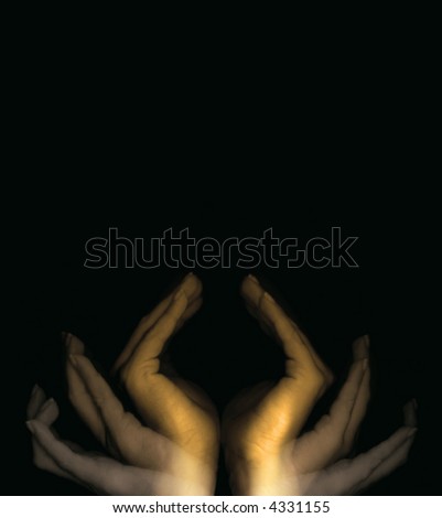 Golden hands closing over black background with copyspace