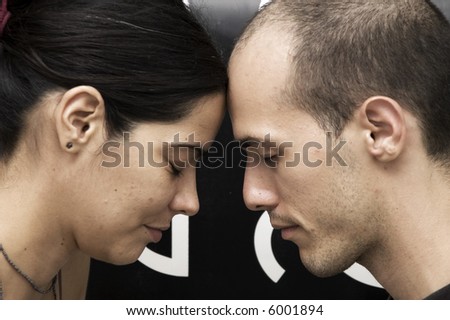Strong connection - Portrait of a young couple head to head meditating with eyes closed