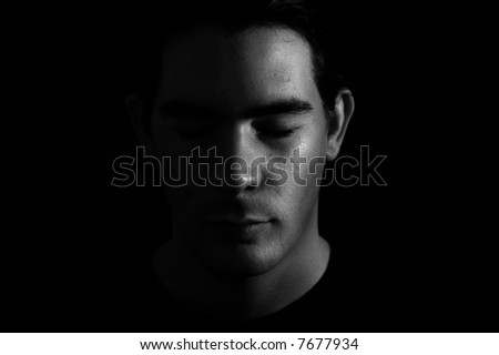 Portrait of a man with half face on shadow