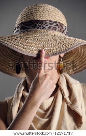 Hat - Portrait of elegant female covering her face with hat