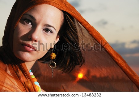 Portrait of beautiful hispanic woman in sunset background