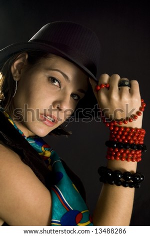 Portrait of young woman in trendy fashion with hat and tie