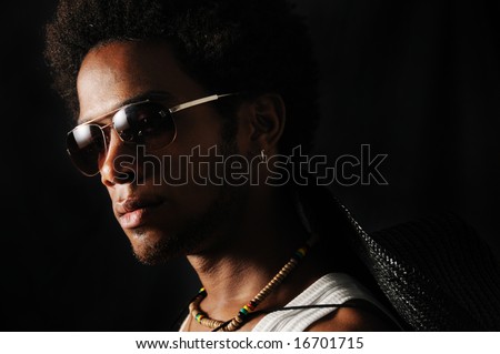 Portrait of young trendy african male with sunglasses