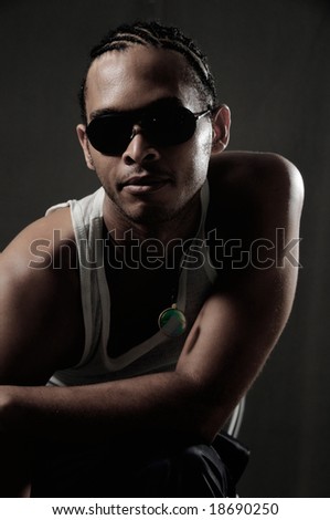 Portrait of young trendy african american man posing