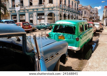 stock photo Vintage classic american cars parked in a street of Old havana