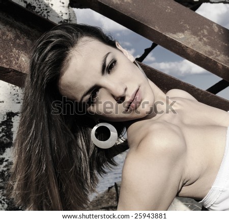 Portrait of young female model posing over grunge background
