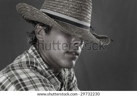 Portrait of young rude man wearing cowboy hat