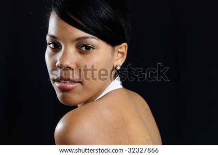 Portrait of young african american beauty posing isolated over black