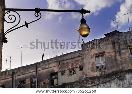 Detail of vintage street lamp and crumbling building in old Havana