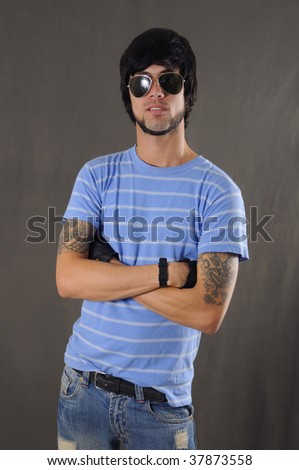 stock photo Portrait of cool young guy with arm tattoo and sunglasses
