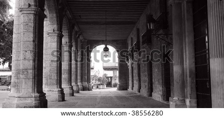 Black and white picture of building corridor with columns in old havana