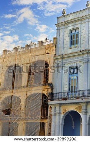 Detail of two colorful buildings in Old Havana under blue sky