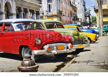stock photo Detail of colorful group of vintage american cars parked in a