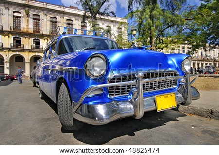 stock photo Blue classic american car in havana street with eroded