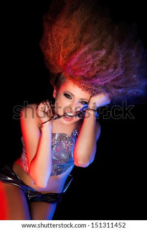 Woman with afro haircut is dancing disco