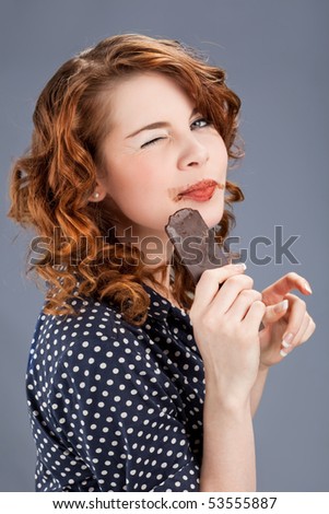young happy smiling woman eating chocolate
