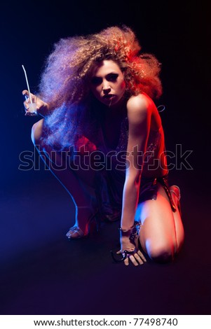 Beautiful blonde woman with handcuffs and  huge afro haircut