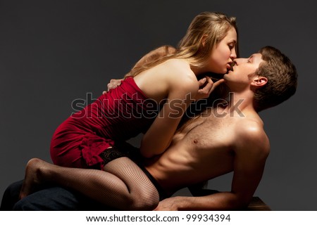 Portrait of a passionate couple, over grey background