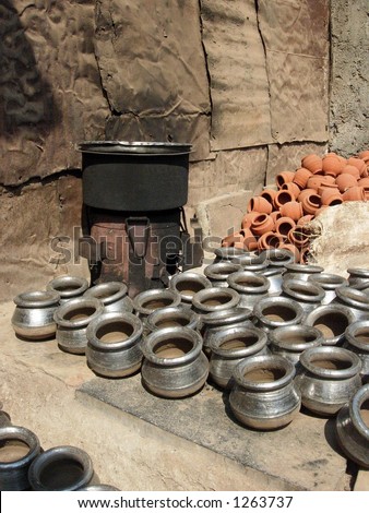 drying pots besides a cooking range in a village in India