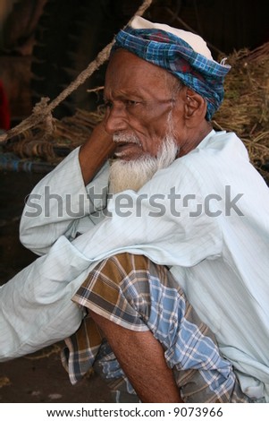 an old man with orange beard in a village in india