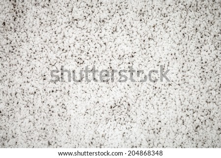 Texture of grime and dirt stuck into the indentations of a white stucco wall