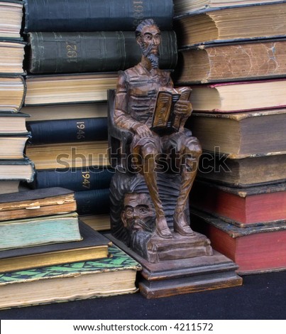 books and wooden sculpture of a reading man