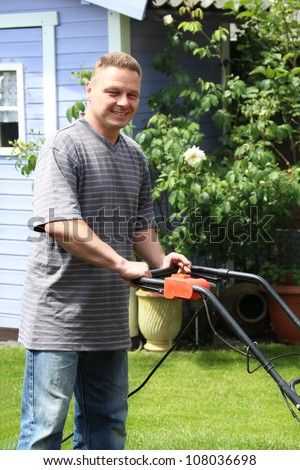 A man in the garden with a lawn mower