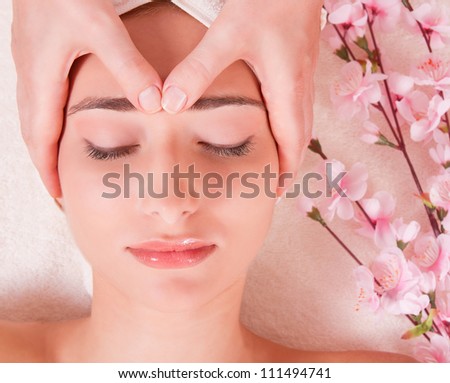 face massage in spa. macro. young woman. close eyes