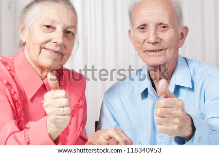 Closeup portrait positive elderly couple happy, thumbs-up gesture