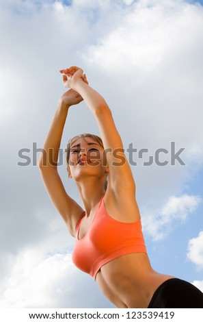 young woman is engaged in outdoor sports, recreation, background blue sky