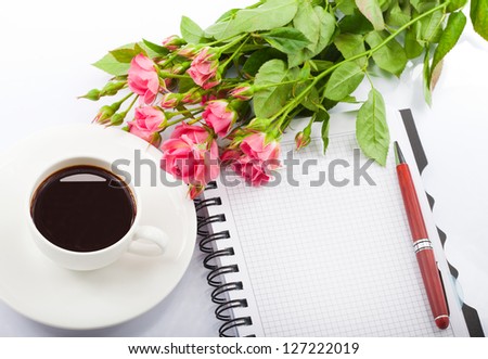 Flowers, coffee and notebook.