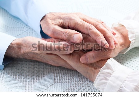Old people holding hands. Closeup.