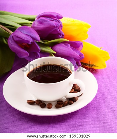 Pleasant evening. Flowers and red gift box. Cup of coffee Close-up.