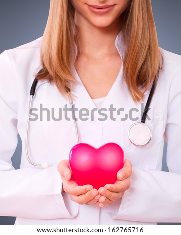 Female doctor holding a heart. the concept of health insurance, life insurance